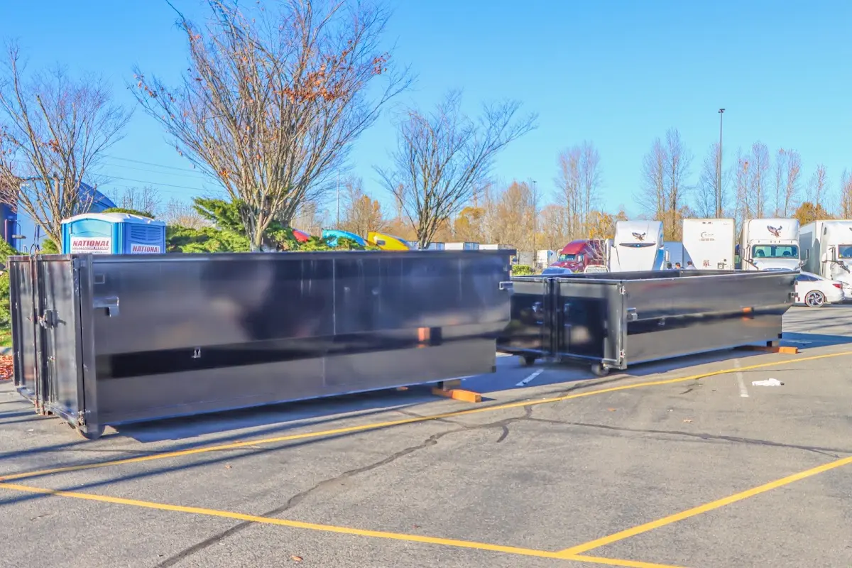 Professional dumpster rental service with roll-off container on residential driveway in Granite City